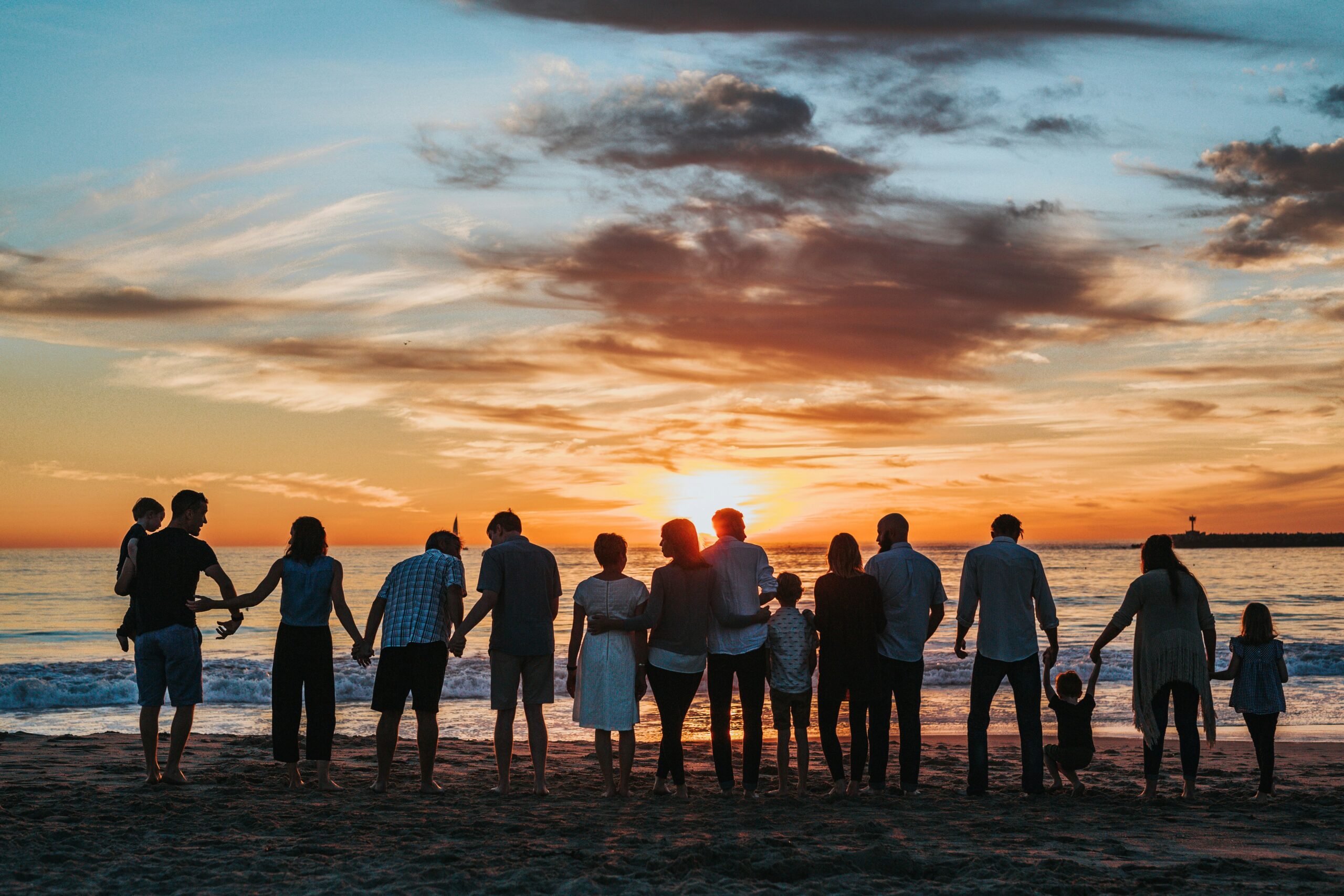 extended family group with adult children at sunset